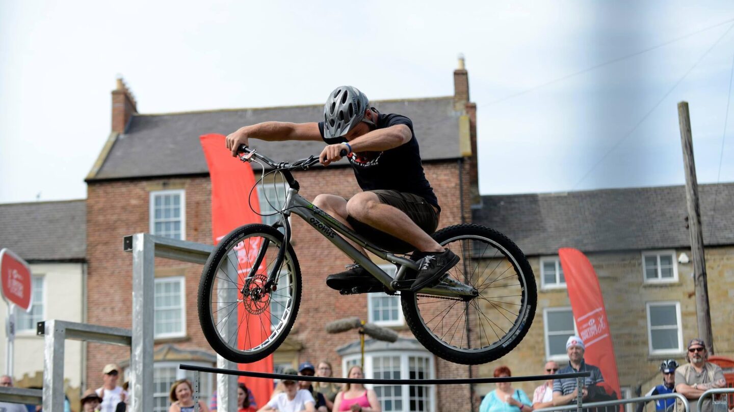 celebrating new bike purchase after being shown how to prepare their bike for sale