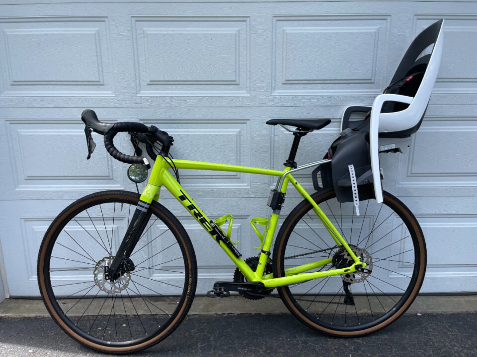 Rear-mounted second-hand bike child seat attached to commuter bike