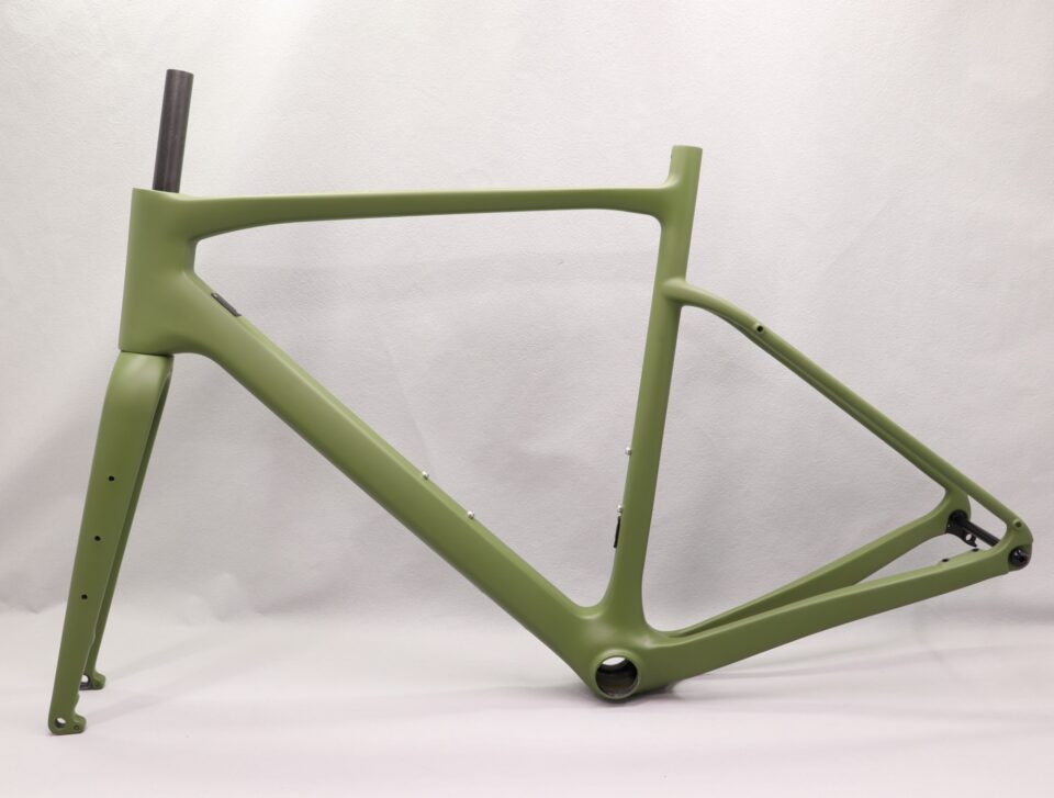 Used full-suspension mountain bike frame on trail backdrop
