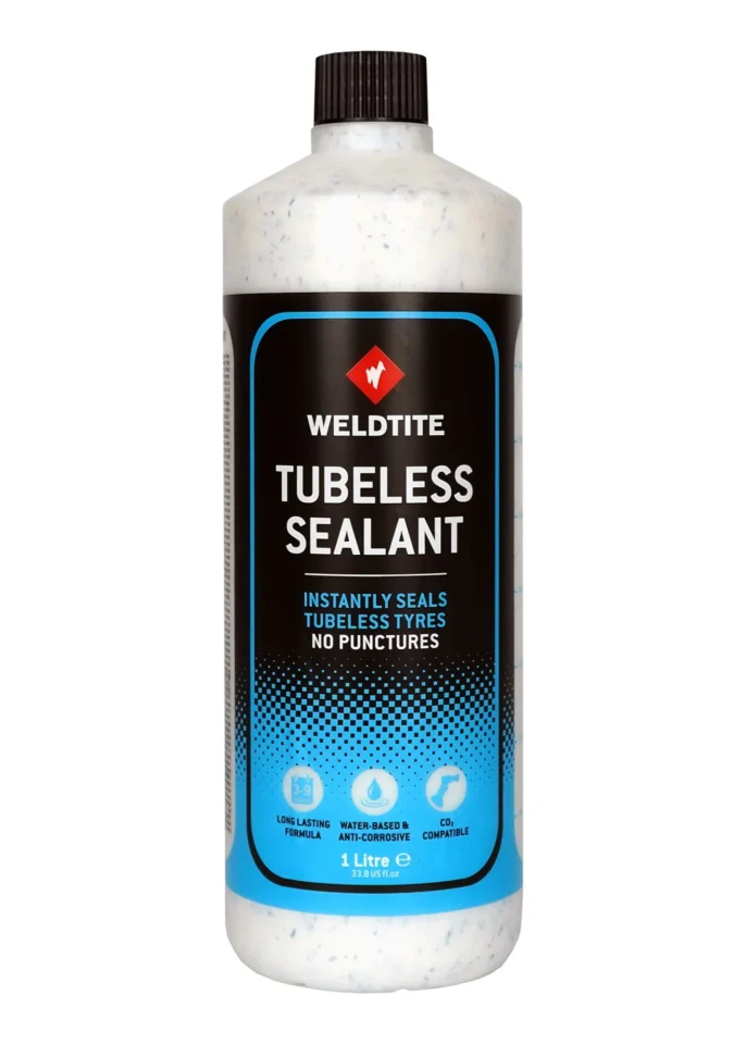 Tubeless sealant for bikes being poured into a tyre